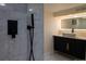 Modern bathroom features a vessel sink, backlit mirror, and high end fixtures at 2441 W 55Th Ave, Denver, CO 80221