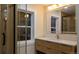 Modern bathroom with double vanity and luxurious shower with glass doors at 2441 W 55Th Ave, Denver, CO 80221