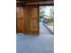 The carport has a wooden slat sliding gate which is open and showcases the backyard at 2441 W 55Th Ave, Denver, CO 80221