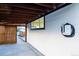 Carport view highlighting its modern design, EV charger, and potential for covered parking and storage at 2441 W 55Th Ave, Denver, CO 80221