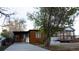 Exterior showcasing the home's contemporary design, carport, and well-maintained front yard at 2441 W 55Th Ave, Denver, CO 80221