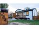 Charming home featuring fresh white siding, black trim, front porch, and easy-to-read address numbers on the mailbox at 2441 W 55Th Ave, Denver, CO 80221