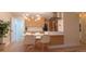 Bright eat-in kitchen features modern lighting, stainless steel appliances, and an island with seating at 2441 W 55Th Ave, Denver, CO 80221