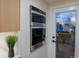 Modern built-in stainless steel oven next to a white-framed glass door at 2441 W 55Th Ave, Denver, CO 80221