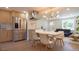 Modern kitchen with stainless steel appliances, a sleek island, and an open dining area perfect for gatherings at 2441 W 55Th Ave, Denver, CO 80221