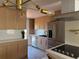 Bright kitchen featuring stainless steel appliances, light wood cabinets, and stylish countertops at 2441 W 55Th Ave, Denver, CO 80221