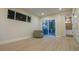 Bright living room with wood floors, a chair, and access to the backyard patio at 2441 W 55Th Ave, Denver, CO 80221