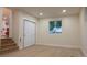 Open living room with wood floors, bi-fold closet doors, and natural light at 2441 W 55Th Ave, Denver, CO 80221