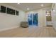 Living room with light wood floors, neutral walls, access to the backyard, and view of the bathroom at 2441 W 55Th Ave, Denver, CO 80221