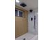 Contemporary shower features sleek fixtures, rainfall shower head, and bench seating at 2441 W 55Th Ave, Denver, CO 80221