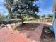 The backyard has a brick pathway, a bench under a large tree, and a wood fence perimeter at 4383 S Eagle Cir, Aurora, CO 80015