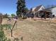 Spacious backyard featuring a brick patio, mature trees, and ample space for outdoor activities at 4383 S Eagle Cir, Aurora, CO 80015