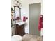 Bathroom with a vanity sink, a large mirror, and a tile floor at 4383 S Eagle Cir, Aurora, CO 80015