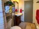 Bathroom featuring vanity, sink, mirror, towels and open shelving at 4383 S Eagle Cir, Aurora, CO 80015