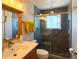 Bathroom featuring a tiled shower with glass door and an updated vanity at 4383 S Eagle Cir, Aurora, CO 80015