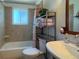 Cozy bathroom showcasing tiled walls, a vanity, and a shower-tub combination at 4383 S Eagle Cir, Aurora, CO 80015