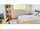 Cozy bedroom features natural lighting and a large display cabinet at 4383 S Eagle Cir, Aurora, CO 80015