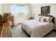Bright bedroom featuring a white bed and white walls with two wooden nightstands at 4383 S Eagle Cir, Aurora, CO 80015