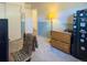 Spare bedroom with chair, wood dresser and view into the hallway at 4383 S Eagle Cir, Aurora, CO 80015