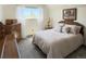 Bright bedroom with a comfortable bed, window, chest of drawers and elegant decor at 4383 S Eagle Cir, Aurora, CO 80015