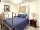Well-lit bedroom featuring a four-poster bed with blue bedding, and two side tables at 4383 S Eagle Cir, Aurora, CO 80015