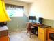 Small bedroom featuring a computer desk, chair, and blue/green painted walls at 4383 S Eagle Cir, Aurora, CO 80015