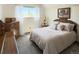 Sunlit bedroom featuring a large window with sheer white curtains and plush bedding at 4383 S Eagle Cir, Aurora, CO 80015
