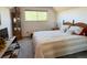 Comfortable bedroom with a large window, soft carpet, and neutral-toned decor at 4383 S Eagle Cir, Aurora, CO 80015