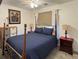 Comfortable bedroom featuring a four-poster bed with stylish bedding and coordinated nightstands at 4383 S Eagle Cir, Aurora, CO 80015