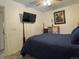 Cozy bedroom featuring a comfortable bed, ceiling fan, and mounted TV at 4383 S Eagle Cir, Aurora, CO 80015