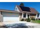 A cozy home with a two-car garage, solar panels, and well-maintained landscaping in front at 4383 S Eagle Cir, Aurora, CO 80015