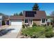 Traditional brick home with solar panels, a well-manicured lawn, attached two car garage, and charming curb appeal at 4383 S Eagle Cir, Aurora, CO 80015