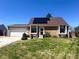 Charming front exterior view of home, manicured front lawn, and solar panels on the roof at 4383 S Eagle Cir, Aurora, CO 80015