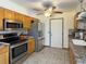 A well-equipped kitchen with modern stainless steel appliances and tile flooring at 4383 S Eagle Cir, Aurora, CO 80015