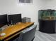 Home office with a desk, monitors and a large fish tank at 4383 S Eagle Cir, Aurora, CO 80015