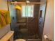 Modern tiled shower with safety handles, window, and sleek glass door at 4383 S Eagle Cir, Aurora, CO 80015