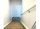 Top view of carpeted staircase with white walls and handrail at 4383 S Eagle Cir, Aurora, CO 80015