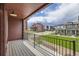 Spacious outdoor balcony area with railing, wood ceiling and views of the neighborhood at 9662 Browns Peak Cir, Littleton, CO 80125
