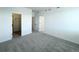 Spacious bedroom showcasing neutral carpet, a walk-in closet, and an ensuite bath at 9662 Browns Peak Cir, Littleton, CO 80125