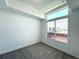Bright bedroom featuring a large window, neutral carpet, and plenty of natural light at 9662 Browns Peak Cir, Littleton, CO 80125
