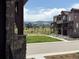 Exterior view of a townhome community featuring manicured landscaping and beautiful mountain views at 9662 Browns Peak Cir, Littleton, CO 80125