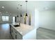 Open concept kitchen with granite counters, stainless appliances, and pendant lighting at 9662 Browns Peak Cir, Littleton, CO 80125