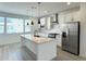 Bright kitchen featuring white cabinets, granite countertops and stainless steel appliances at 9662 Browns Peak Cir, Littleton, CO 80125