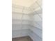 Walk-in pantry with adjustable white wire shelving for optimal storage and organization at 9662 Browns Peak Cir, Littleton, CO 80125