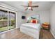 Bright bedroom with sliding glass door to yard, ceiling fan, and modern decor for comfortable living at 1148 S Ventura Cir # C, Aurora, CO 80017