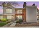 Charming townhouse with a brick chimney, a small porch, and lush landscaping in a well-maintained community at 1148 S Ventura Cir # C, Aurora, CO 80017
