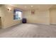 Spacious finished basement with carpet flooring and a window for natural light at 2485 Greensborough Cir, Highlands Ranch, CO 80129