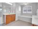 Well-lit bathroom with double vanities, soaking tub, and modern fixtures at 2485 Greensborough Cir, Highlands Ranch, CO 80129