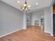 Bright dining room with hardwood floors and an open archway to the kitchen at 2485 Greensborough Cir, Highlands Ranch, CO 80129