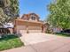 Charming two-story home featuring a large driveway and a well-maintained front yard with mature trees at 2485 Greensborough Cir, Highlands Ranch, CO 80129